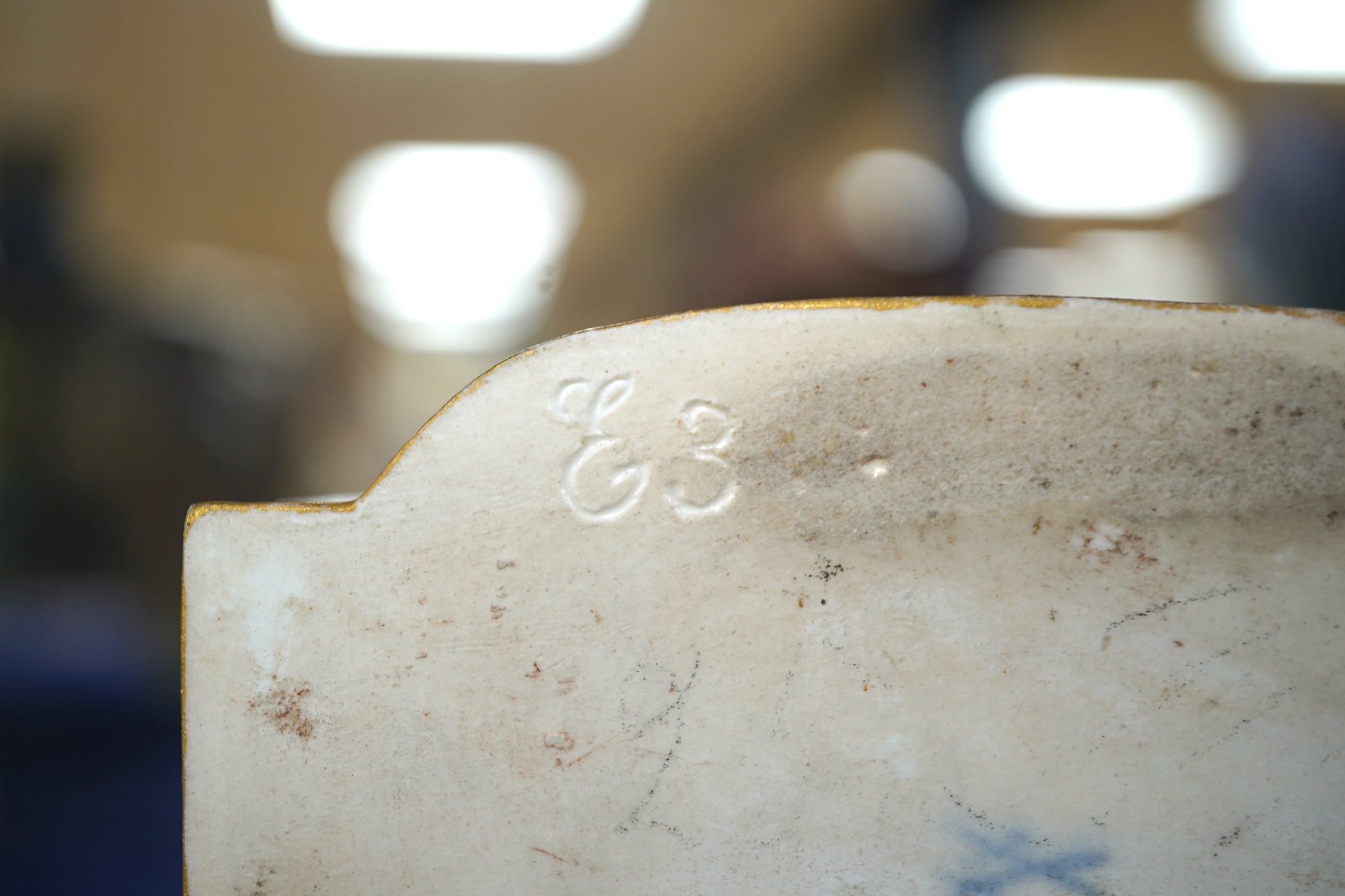 A late 19th century Meissen figure of Sight, from the Senses, a seated lady at her dressing table, crossed swords mark and incised E3 mark to base, 14cm high